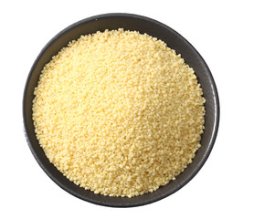 Couscous in black bowl isolated on white background. top view