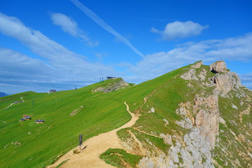 Hiking trail leading around peaks of picturesque Seceda Alpine meadows during summer, Ortisei,...