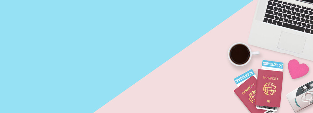 travel banner advertising with two passport, boarding pass , camera , coffee and computer laptop isolated on two tone color background with copy space. traveling by air concept