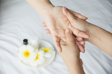 Fototapeta premium Hand spa massage over clean white bed background - people relax with hand massage service