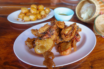 Special thai food fried chicken on wooden table.