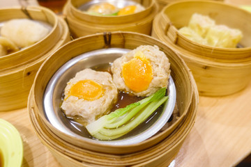 Pork with salted egg Dim Sum in Bamboo Steamer Basket.