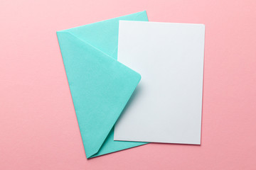 Green envelope and blank letter on pink background. Template with place for text on postcard....