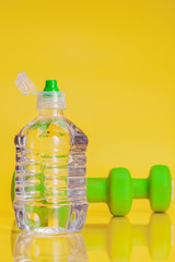 Plastic bottle of mineral water on a bright yellow background