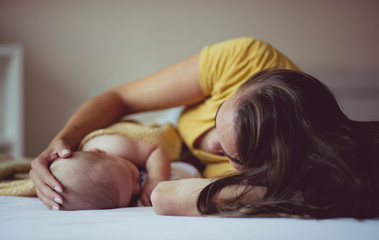 Obraz na płótnie Canvas Falling asleep with her baby.