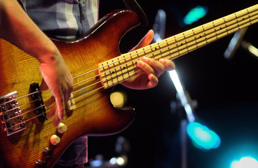 Obraz na płótnie Canvas guitarist playing electrical bass guitar on a jazz concert