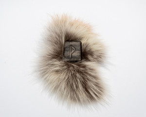 Norse rune Vunjo, isolated on fur and white background. Joy, luck, fulfillment of desires.