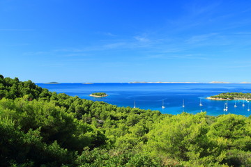 Beautiful beach and camp in Kosirina on Island Murter, Adriatic sea, Croatia. National park Kornati in background.