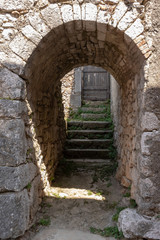 Fototapeta na wymiar Old stone entrance to the ancient house in medieval town Beli on island Cres, Croatia