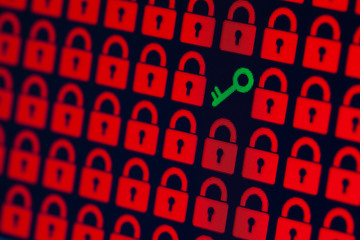 Key as a symbol of access or hacking of open personal information. Red pixel locks and a green key on a black background, close-up