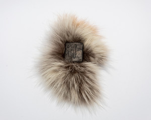 Norse rune Isa, isolated on fur and white background. Calmness, stability or delay, stagnation.
