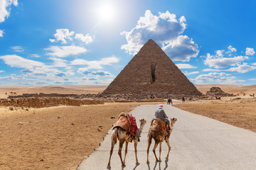 Road to the Pyramid of Menkaure and the bedouin with camels, Giza, Egypt
