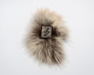 Norse rune Sowilo, isolated on fur and white background. The sun, energy, protection from dark forces.