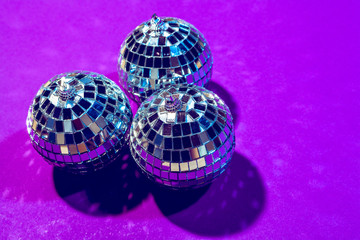 disco ball shines on purple background close up