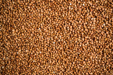 The texture of dry buckwheat. Background image of buckwheat porridge. Maro's Photo