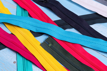 Pack lot of colorful plastic and metal zippers stripes with sliders pattern for handmade sewing...