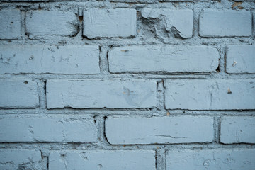 Texture of an old paint covered brick wall. Background image of an abandoned brick wall with painted over paint
