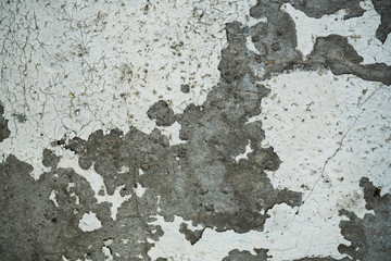 Texture of an old cracked concrete wall. Background image of a worn gray concrete surface