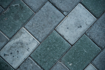 Texture of paving slabs overgrown with grass. Background image of a stratum stone