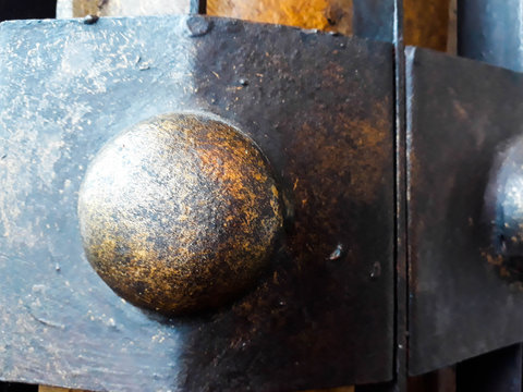 detail of screw, Rust with Circle, Metal, steel, brilliant bolt in an orange wooden board. Macro, Surface of rusty metal and rivet. Rust texture, Close up view of antique wood gate with metal decor