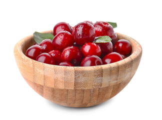 Bowl with ripe sweet cherry on white background