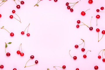 Frame made of ripe sweet cherry on color background