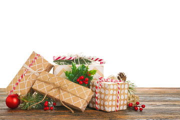 Beautiful Christmas gifts on wooden table against white background