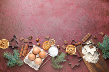 Christmas composition with cookie cutters and ingredients on color background
