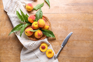 Tasty peaches on wooden table