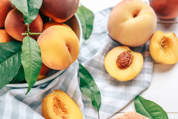 Bowl with tasty peaches on table