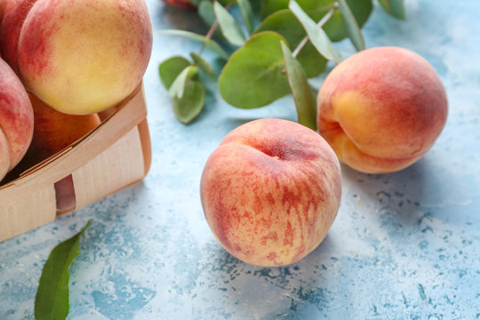 Tasty peaches on color background