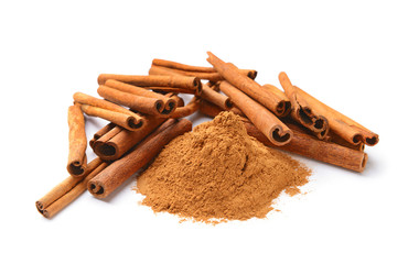 Aromatic cinnamon sticks and powder on white background