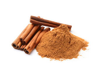 Aromatic cinnamon sticks and powder on white background