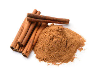 Aromatic cinnamon sticks and powder on white background