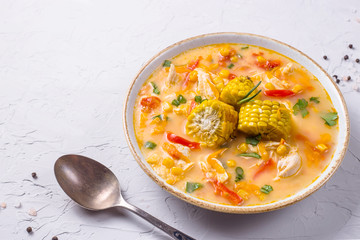Soup with corn garnished with slices of ripe corn pumpkin