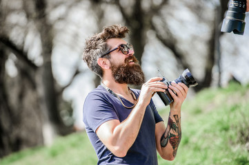 Give me a smile. hipster man in summer sunglasses. photo of nature. reporter or journalist. Mature...
