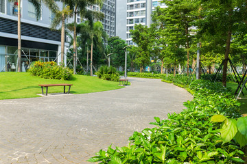Urban walking road among green tree in modern apartment buildings in big city. © Hanoi Photography