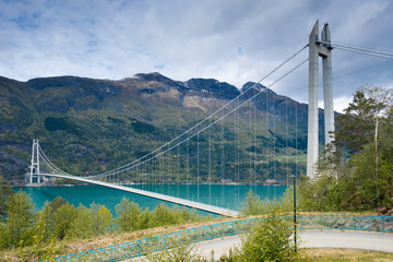 Hardanger Bridge is a suspension bridge across the Eidfjorden branch of Hardangerfjorden in Hordaland county, Norway. 