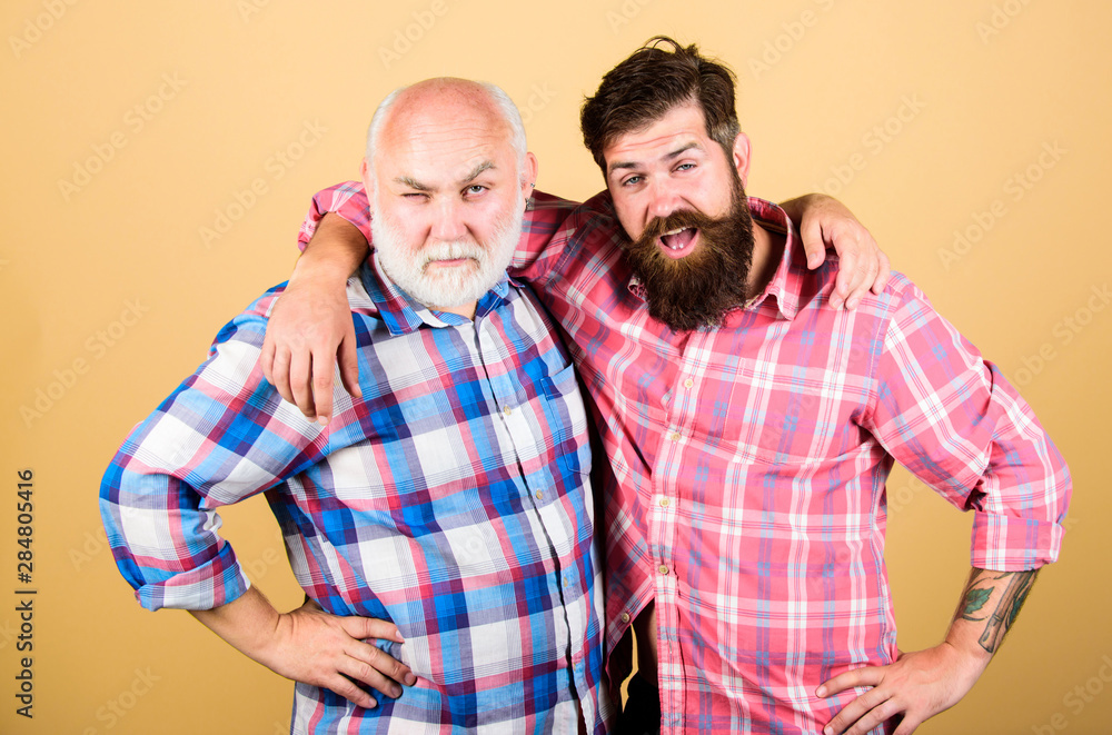 Wall mural native people. barbershop and hairdresser salon. male beard care. checkered fashion. father and son family. generational conflict. youth vs old compare. retirement. two bearded men senior and mature