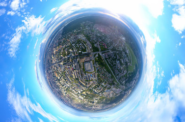 Aerial view of the city with traffic, streets and buildings with green trees and rails under the...