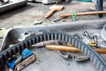 Old belt of scooter motorbike on tooling tray