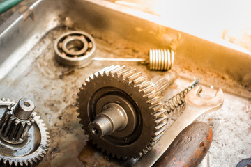Old shiny motorcycle gears. Disassembly of the engine