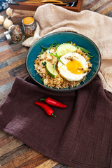 Wok rice cooked with soy sauce, vegetables and chicken pieces.