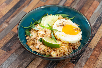 Wok rice cooked with soy sauce, vegetables and chicken pieces.