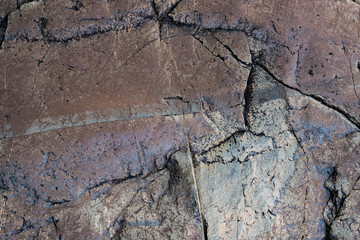 The texture of the stone overgrown with moss. Background image of a boulder