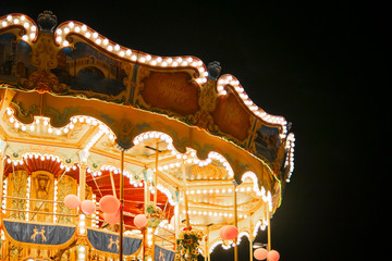 Children's Carousel at an amusement park in the evening and night illumination. Attractions park....