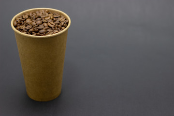 coffee beans in a glass on a dark background place for text