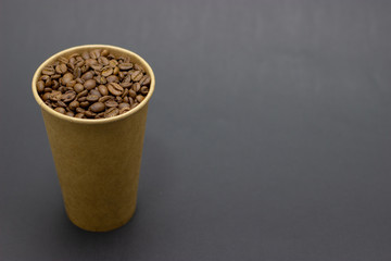 Fototapeta na wymiar coffee beans in a glass on a dark background place for text
