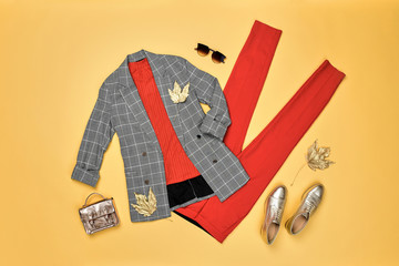 Autumn Arrives. Fashion Lady Clothes fall Outfit. Trendy jacket, red trousers. Stylish gold...
