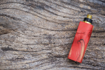 high end red natural stabilized wood regulated box mods with rebuildable dripping atomizer on...
